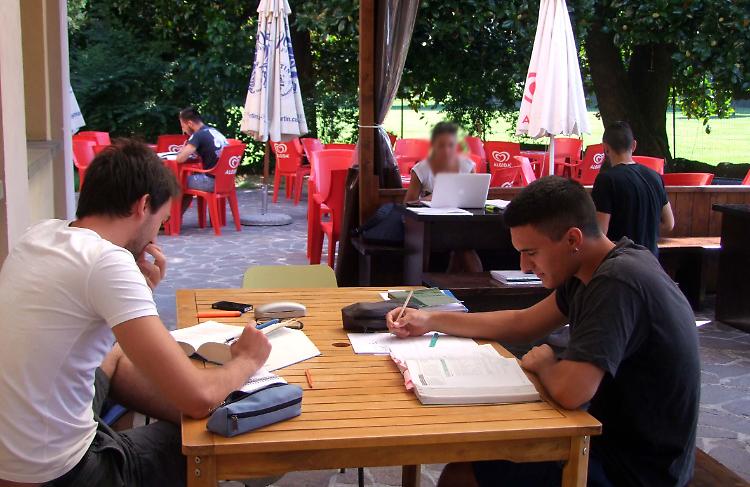 Studenti alle prese con i libri di scuola a villa San Giuseppe