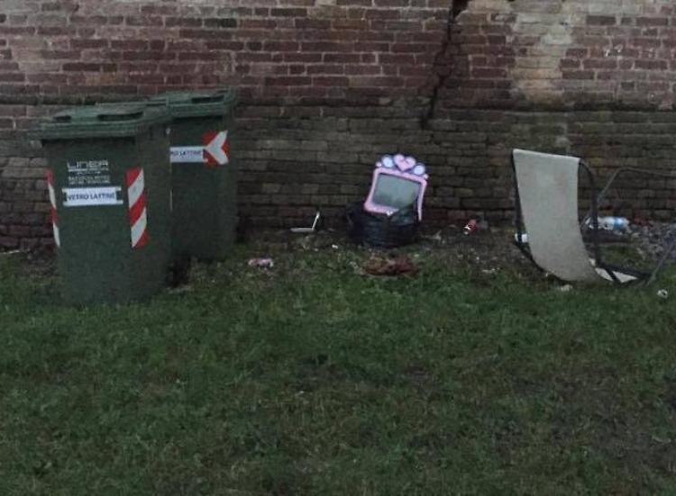 Rifiuti buttati sotto le mura del castello