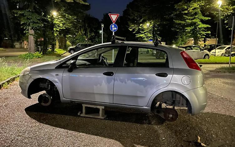 Auto in bilico su due mattoni senza ruote